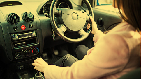 Stalling and clutch control A young driver restarting her car after stalling